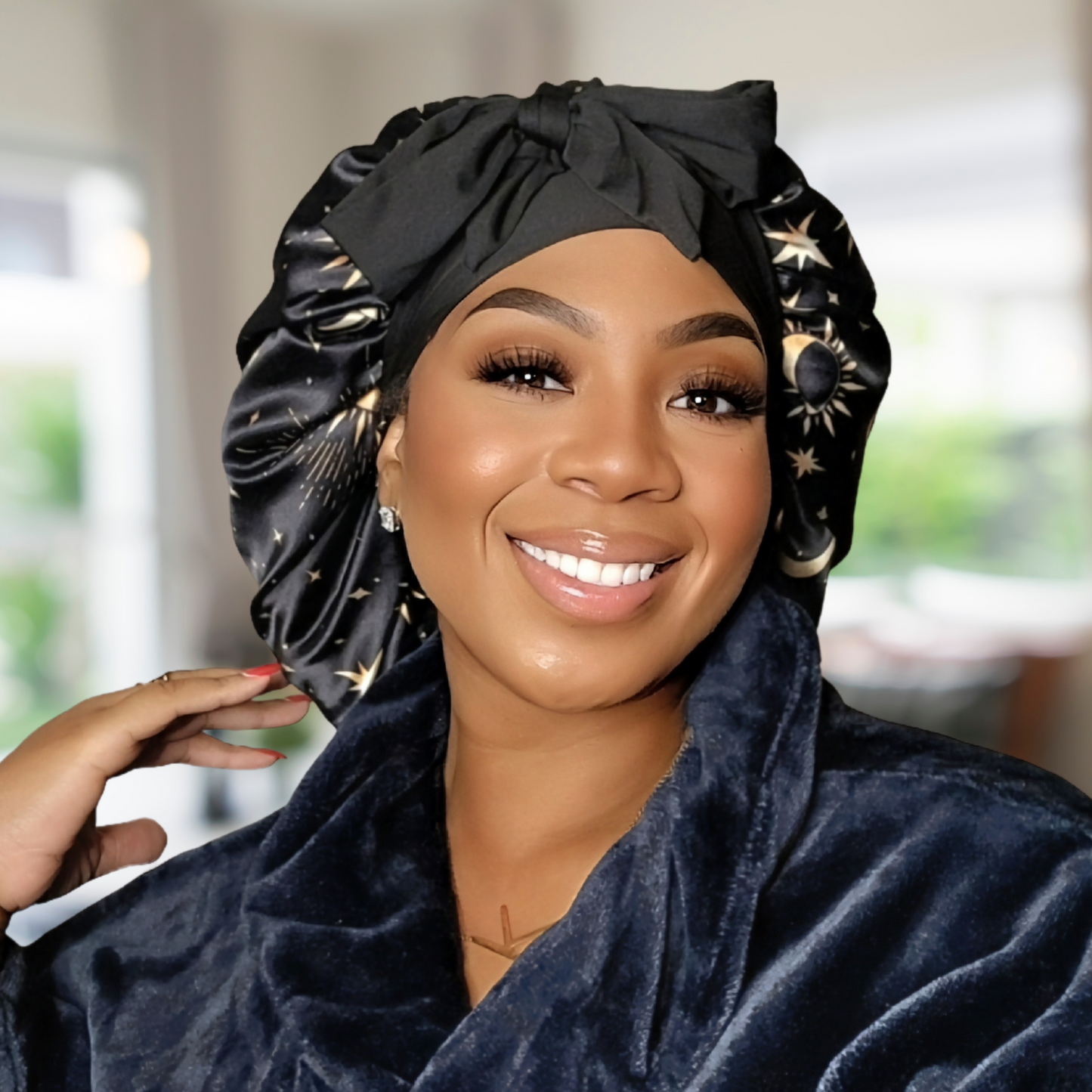 Beautiful model wearing adjustable satin hair bonnet in Starry Night print, showing full coverage fit for natural, curly, and textured hair. Comfortable and stylish sleep cap for nighttime use