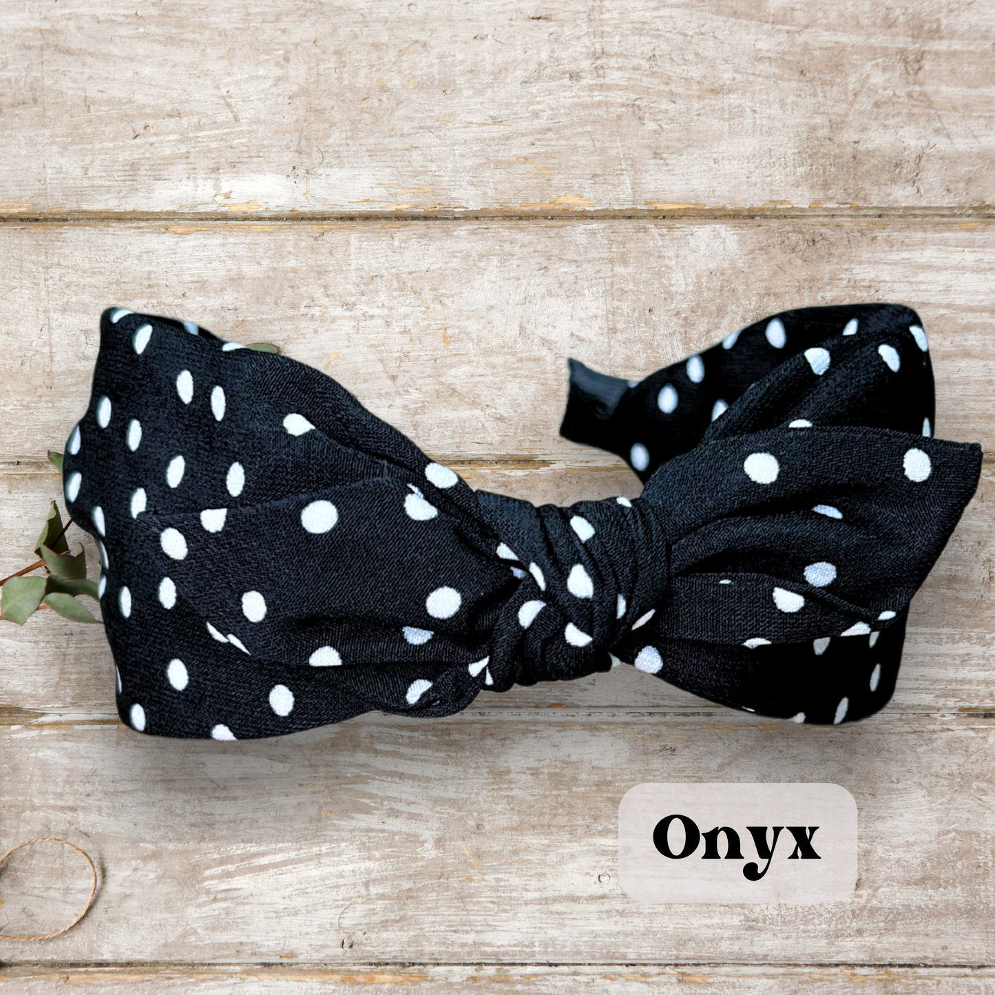 Black colored Retro rabbit ear headband with twist knot design in vintage colors, perfect for a stylish and classic look