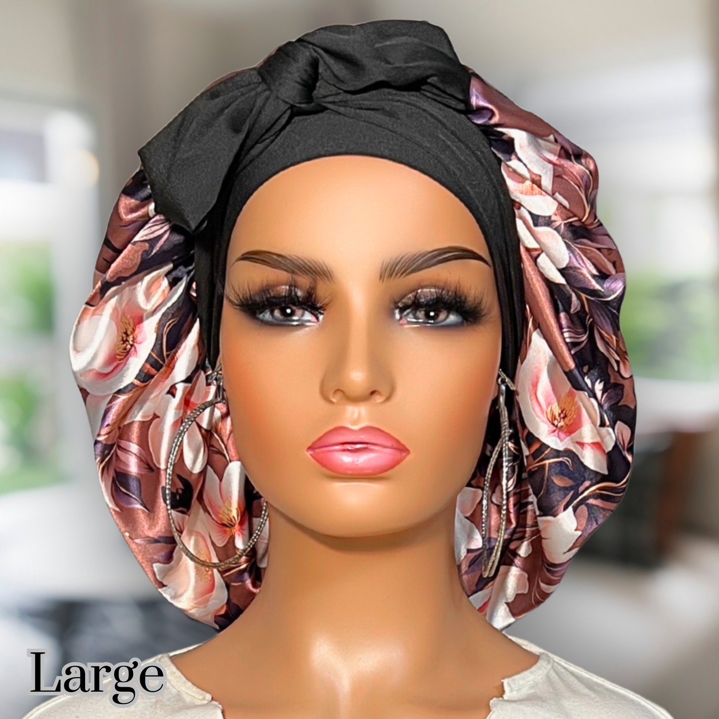 Beautiful brown magnolia flower bonnet with a silky satin gold lining with long black stretch ties being worn by an African American model.