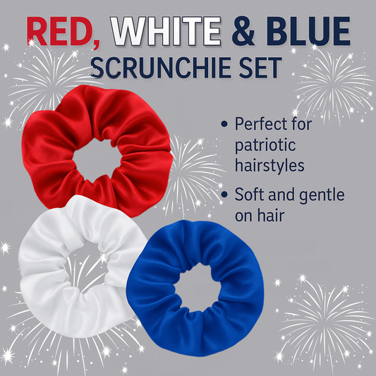 Red, white, and blue satin scrunchie set arranged in a flat lay on a white wood background, perfect for patriotic hairstyles.