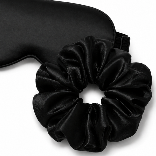 Close-up of satin eye mask and oversized scrunchie sleep set