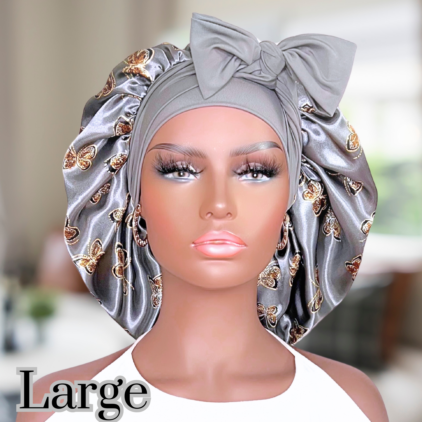 Beautiful stretch tie gray butterfly printed satin lined satin hair bonnet on a African American mannequin