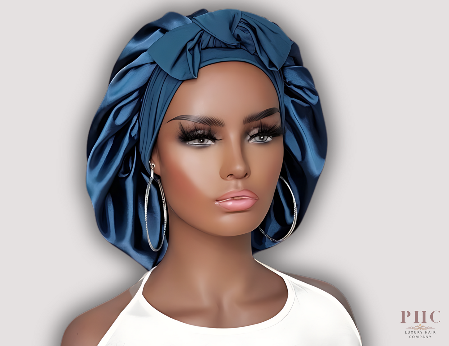 Beautiful African-American mannequin wearing a midnight blue satin hair bonnet on a gray background.