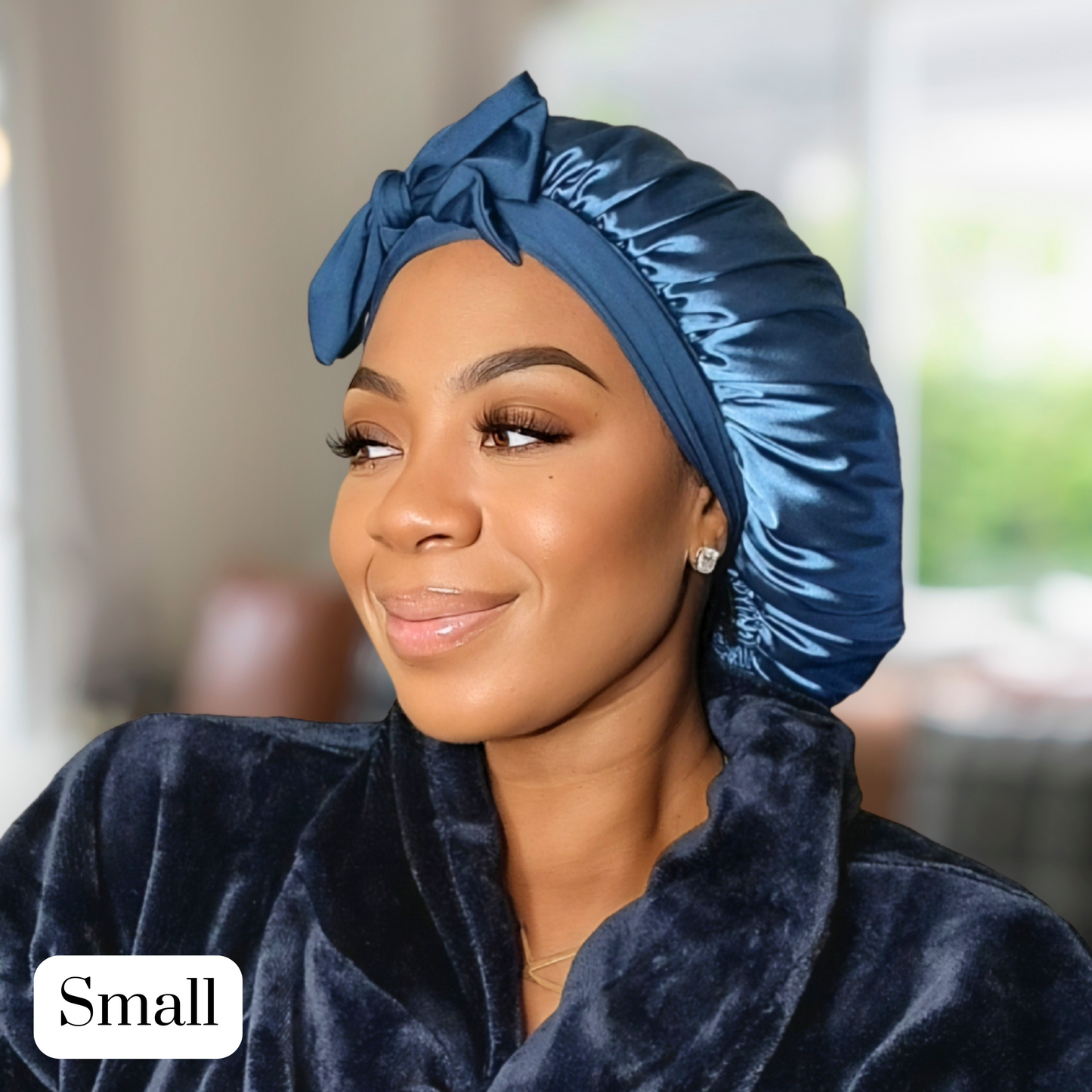 Model wearing a Peacock blue Stretch Tie satin hair bonnet tied in a bow. The bonnet is showcasing a smooth satin texture and vibrant color. Ideal for curly, natural, and protective hairstyles.