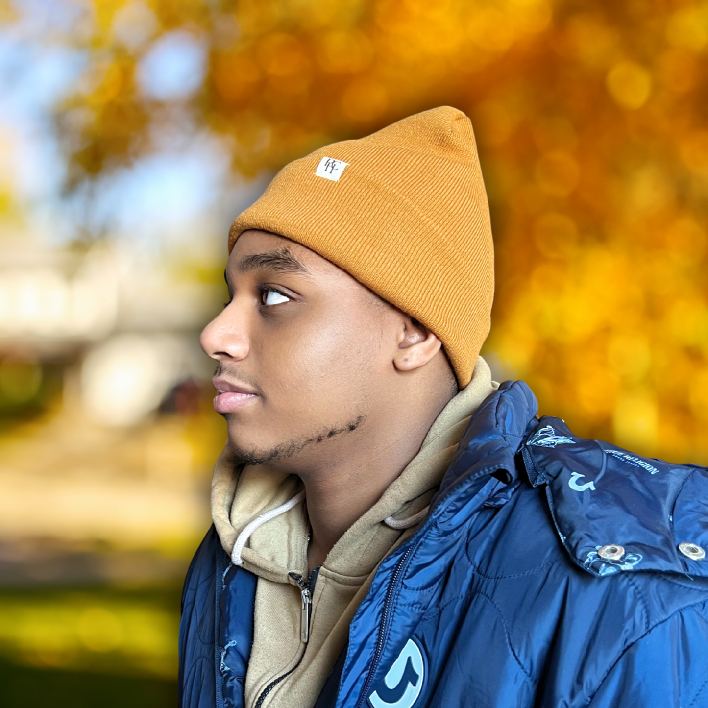 African American Male wearing PHC Prince Hair Company Camel colored satin lined beanie on a fall background