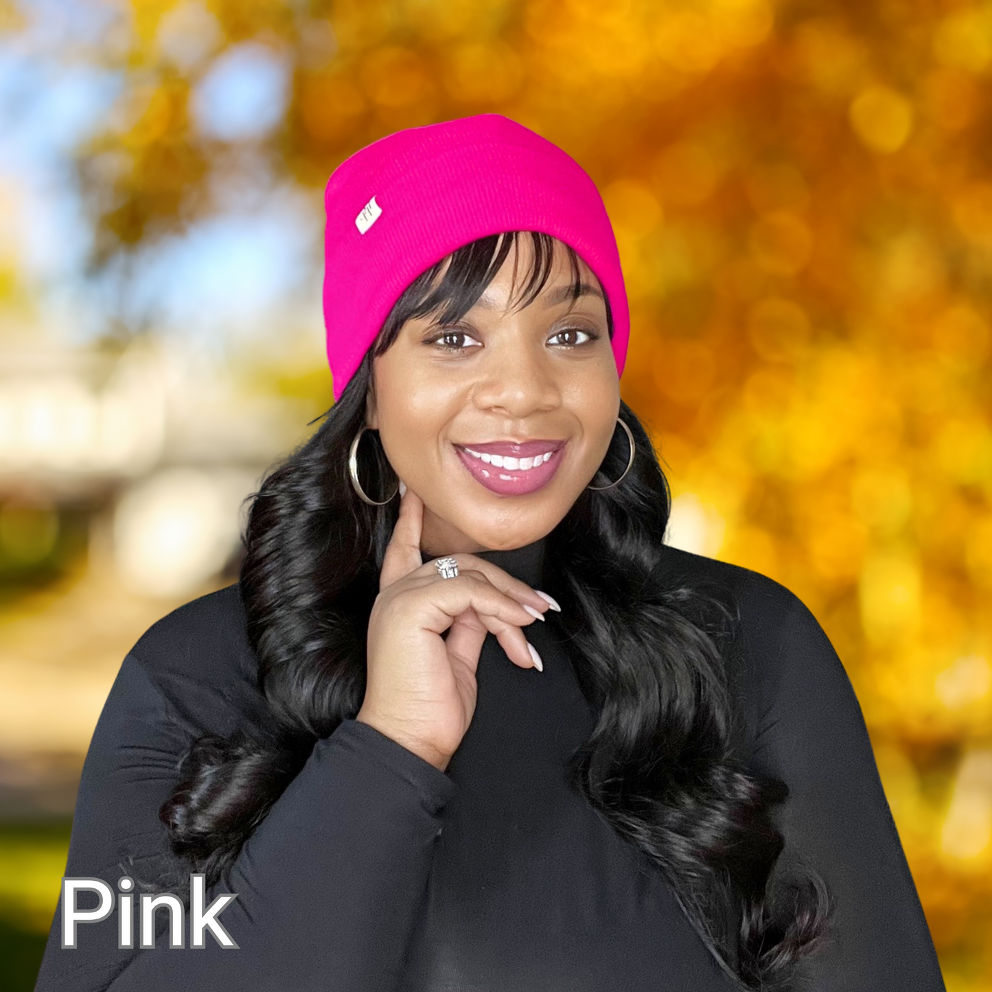 African American female modeling a PHC Prince Hair Company satin lined Pink beanie on a blurred out fall background.