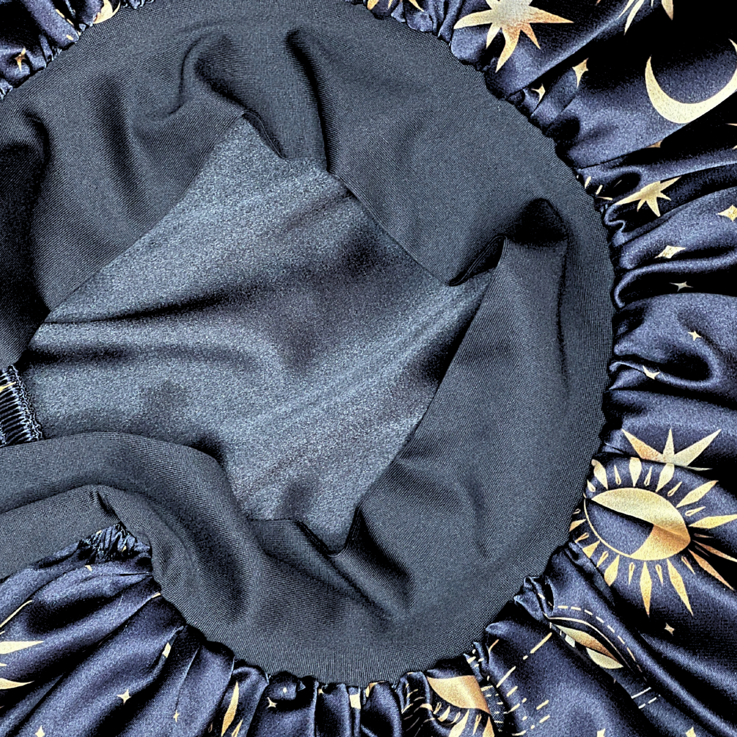Close up details of the Satin Lined Bonnet in Custom PHC Starry Print with adjustable stretch ties. Perfect silky satin sleep cap for protecting your hair throughout the night.