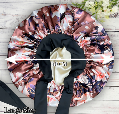 Beautiful brown magnolia flower bonnet with a silky satin gold lining with long black stretch ties on a wooden background. 