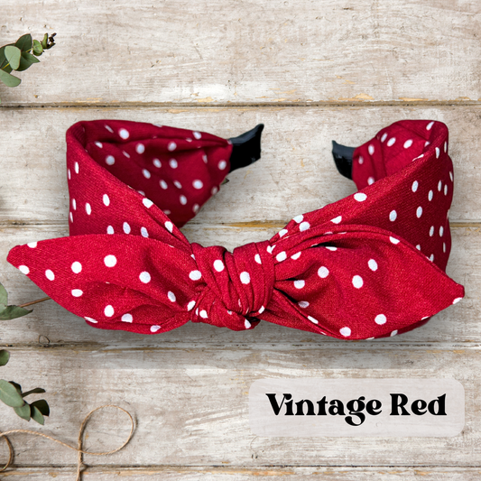 Red colored Retro rabbit ear headband with twist knot design in vintage colors, perfect for a stylish and classic look