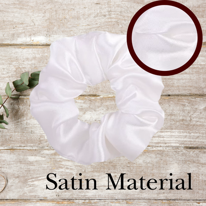 Close-up of soft satin scrunchies in red, white, and royal blue, highlighting their glossy texture and stretch