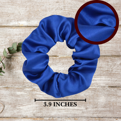 Close-up of soft satin scrunchies in red, white, and royal blue, highlighting their glossy texture and stretch