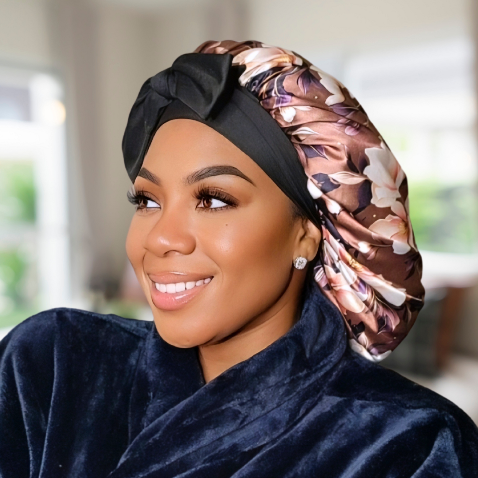 Beautiful brown magnolia flower bonnet with a silky satin gold lining with long black stretch ties being worn by an African American model.