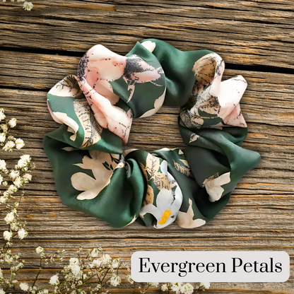 hunter green floral satin scrunch on a wooden plank background. Evergreen petals