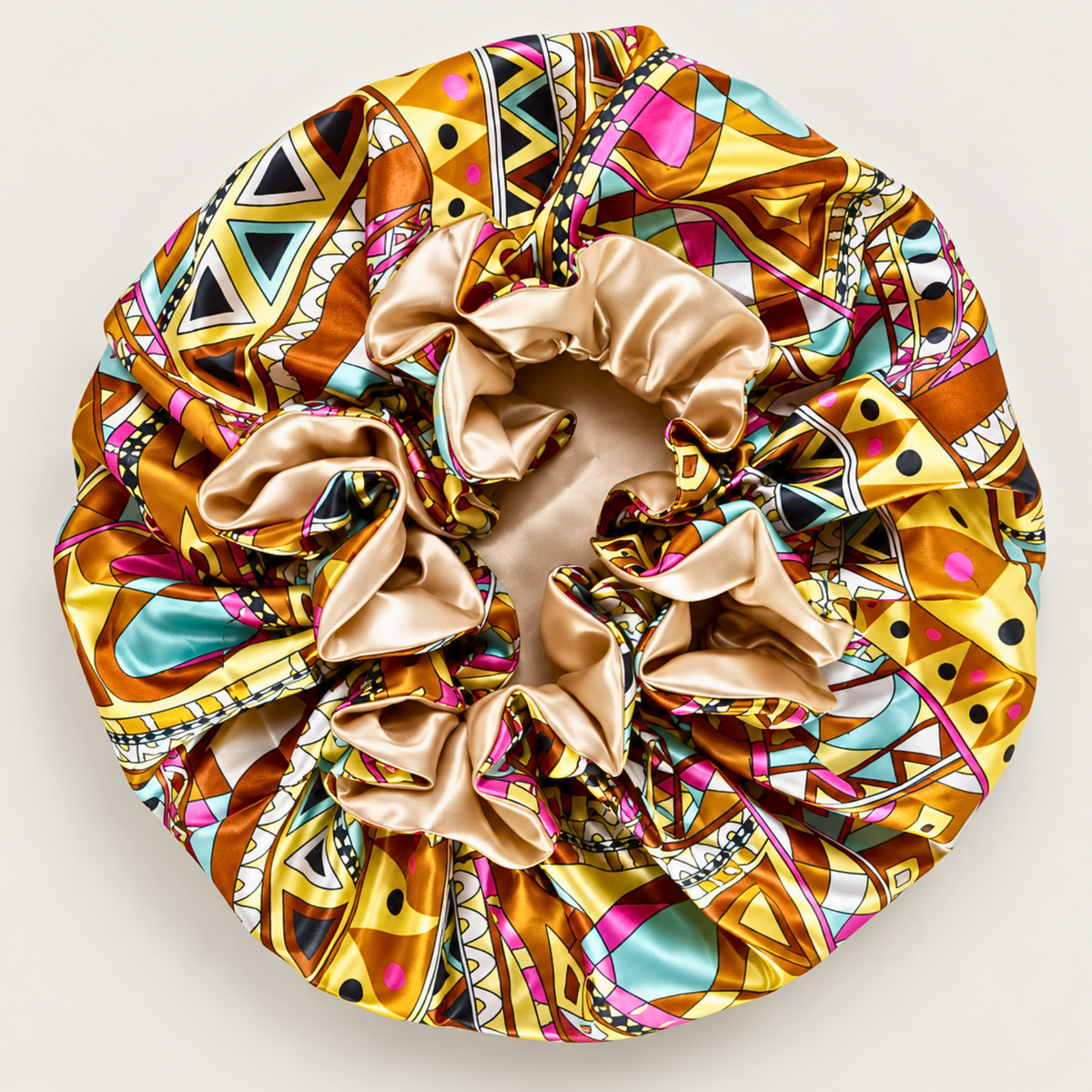 Champagne Ankara ruffle satin bonnet laid flat, Ankara print with champagne satin band