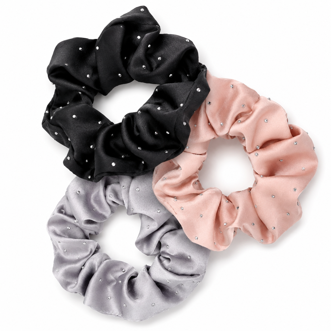 Three-piece rhinestone satin scrunchie set arranged on a white background