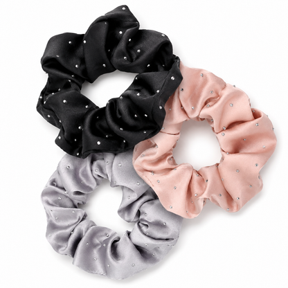 Three-piece rhinestone satin scrunchie set arranged on a white background