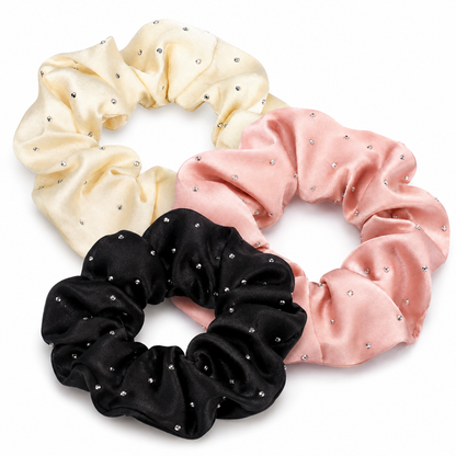 Three rhinestone satin scrunchies in cream, blush pink and black