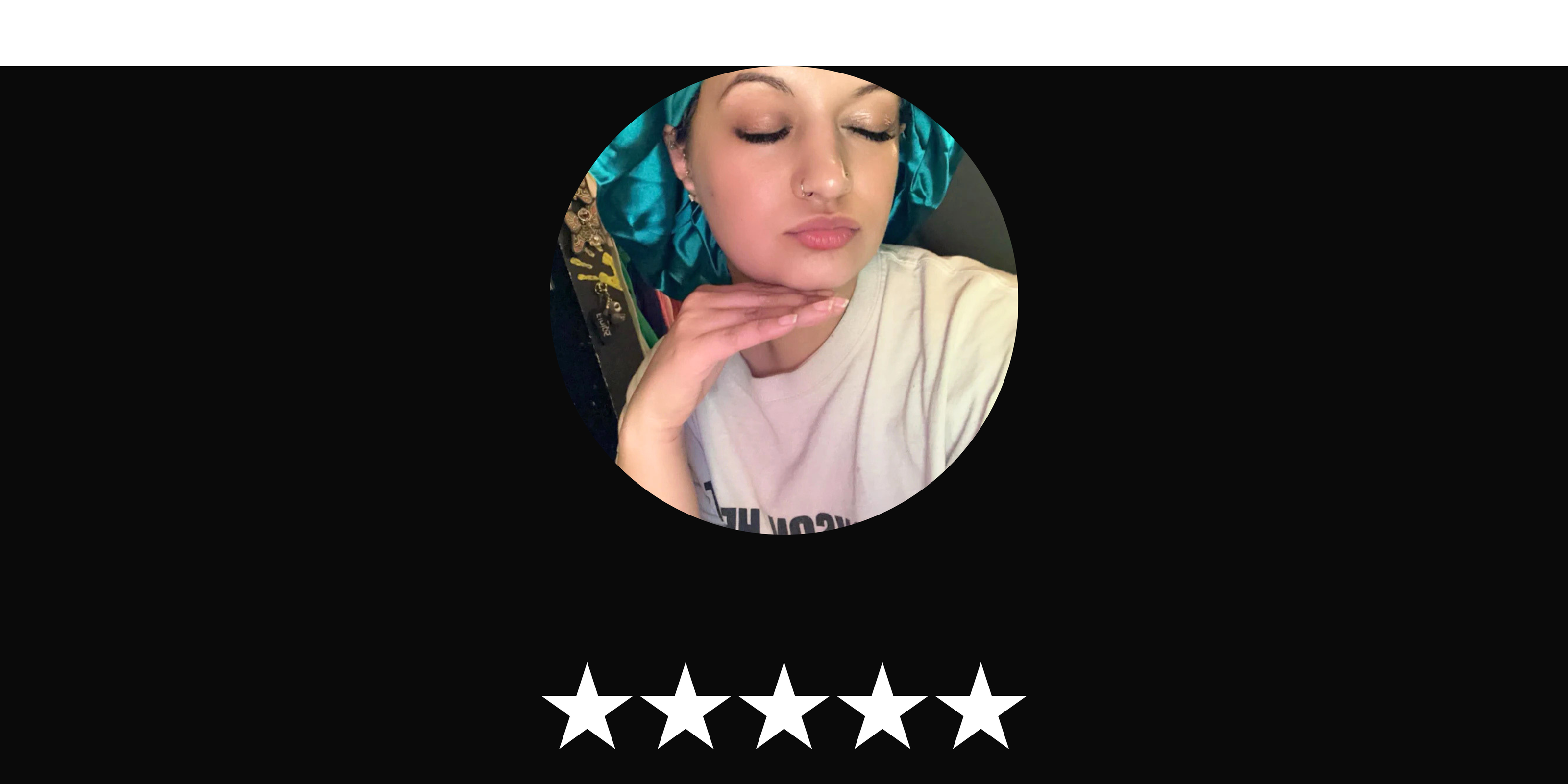 Circular profile picture of a woman wearing a Prince Hair Company Original Stretch Tie Satin Bonnet with  five white stars blow the image on a black background.