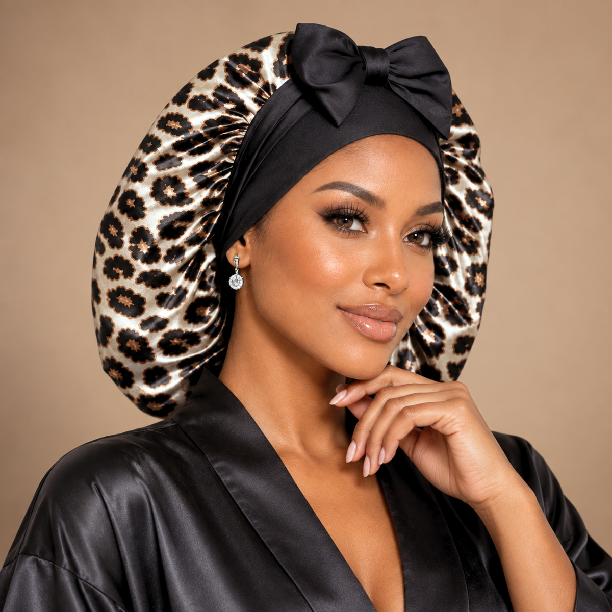 Leopard Print silk-blend satin bonnet with stretch ties, large size – front view with black bow, worn with a black satin robe