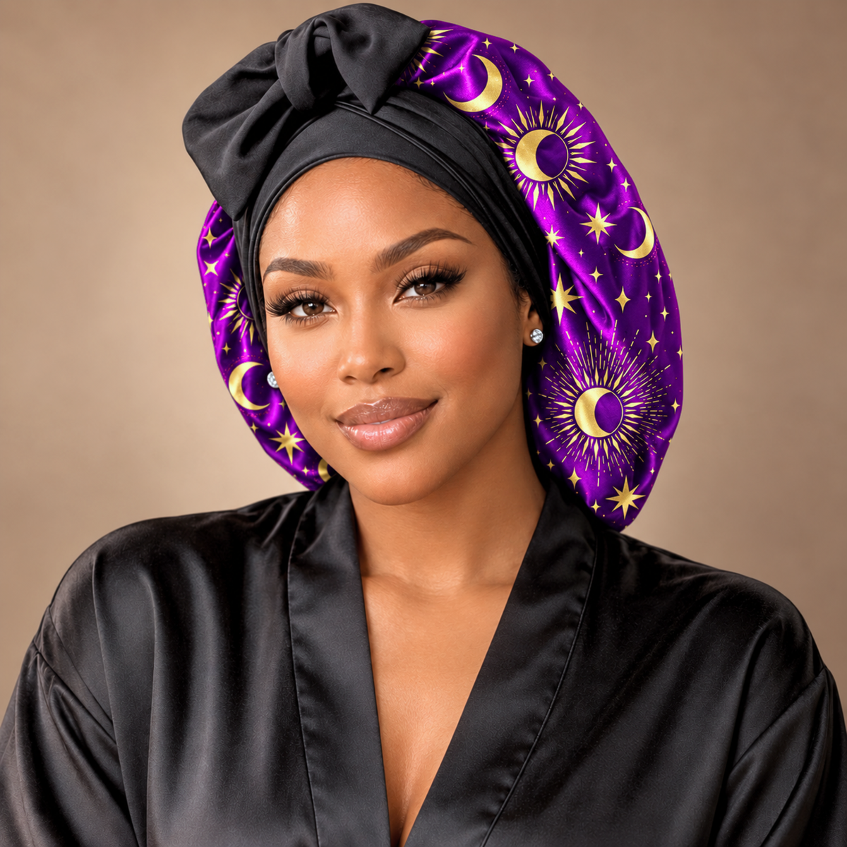 Celestial Dream silk-blend satin bonnet with stretch ties, large size – front view of the purple and gold celestial print, worn with a black satin robe