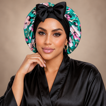 Teal Flowers silk-blend satin bonnet with stretch ties, small size – front view with black bow, worn with a black satin robe