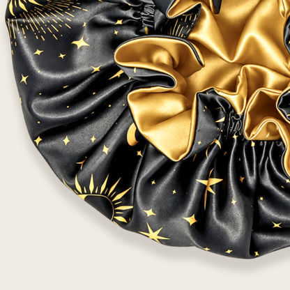 Close-up of the Starry Night ruffle satin bonnet showing the gold satin band