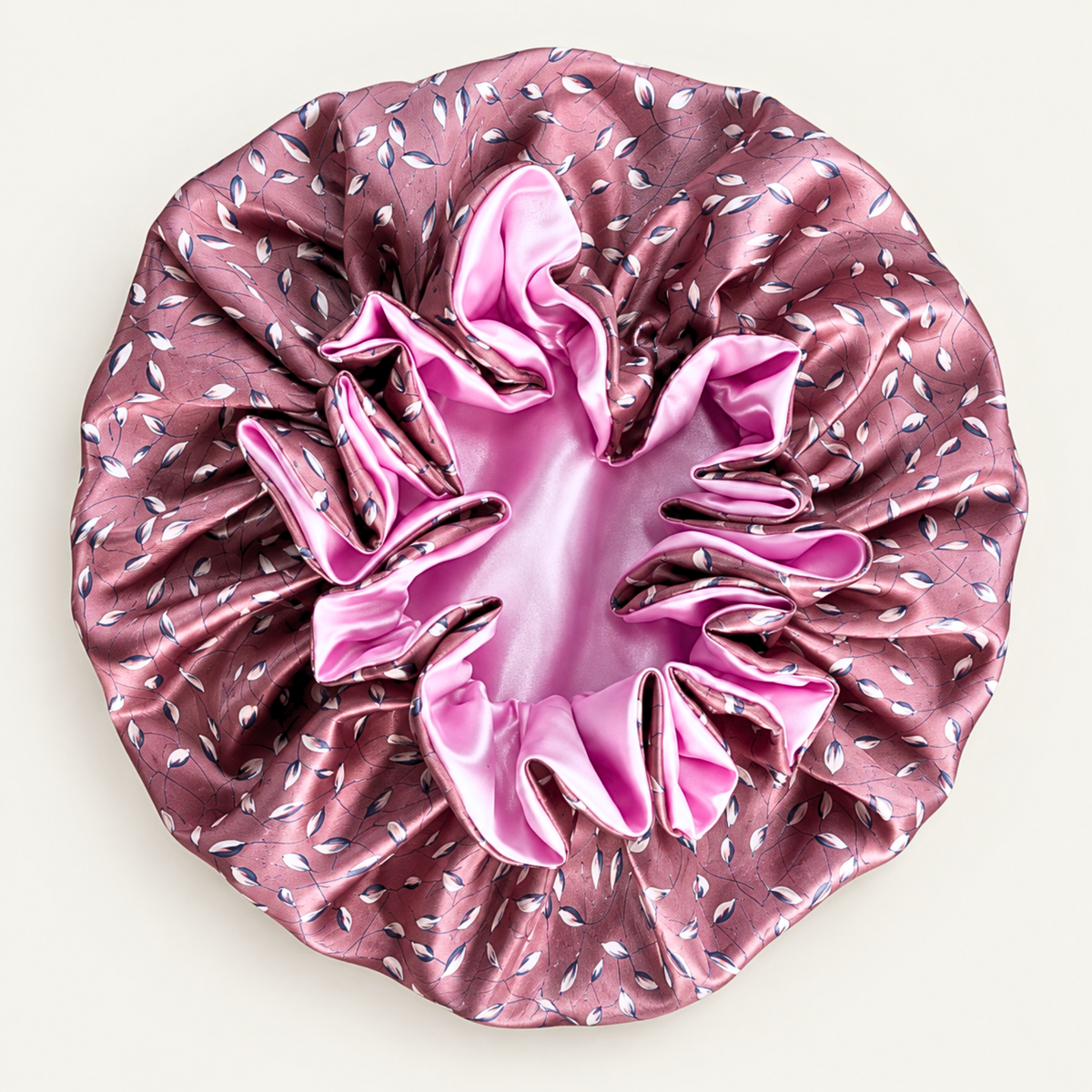 Vintage Pink Petals ruffle satin bonnet laid flat, dusty pink leaf print with pink ruffles