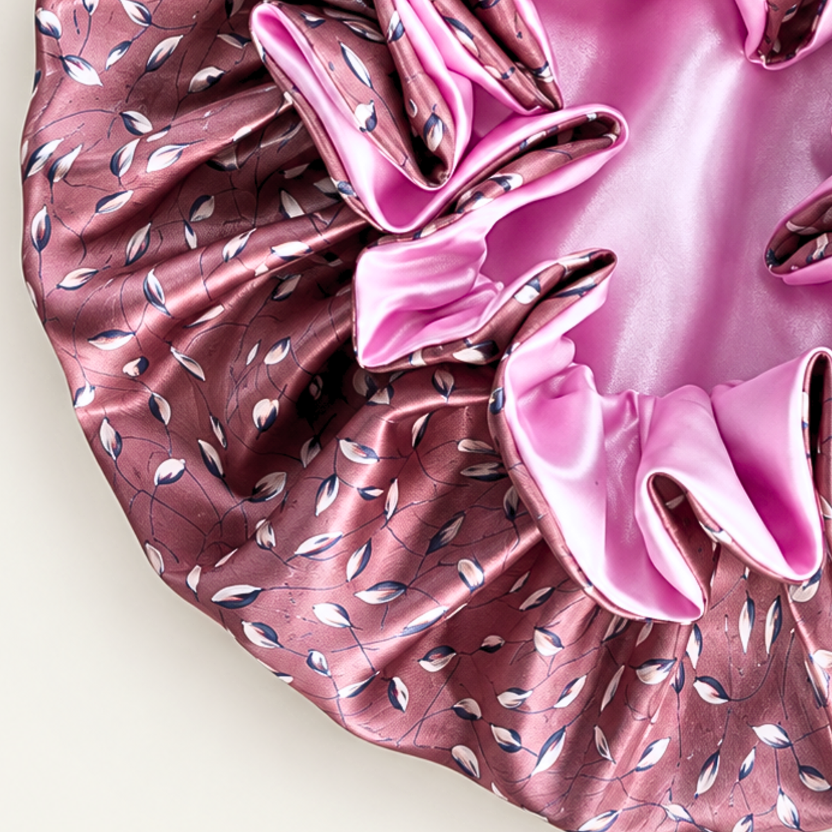 Close-up of the Vintage Pink Petals ruffle satin bonnet showing the bright pink side