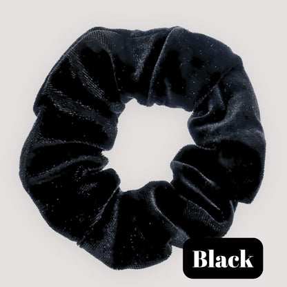 A single Black handmade velvet scrunchie for damage-free hair styling on a light background, featuring a black label reading 'Black'.