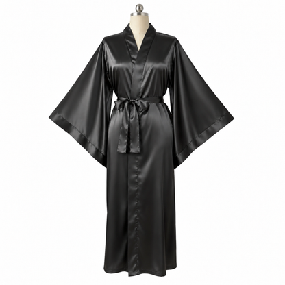A black satin kimono-style robe with wide sleeves and a self-tie belt, displayed on a mannequin against a plain white background.