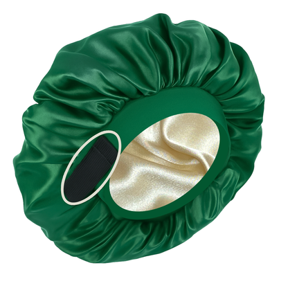Green satin bonnet with a gold interior on a white background