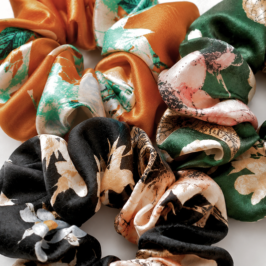Close-up of charmeuse satin scrunchie showing soft floral print and sheen