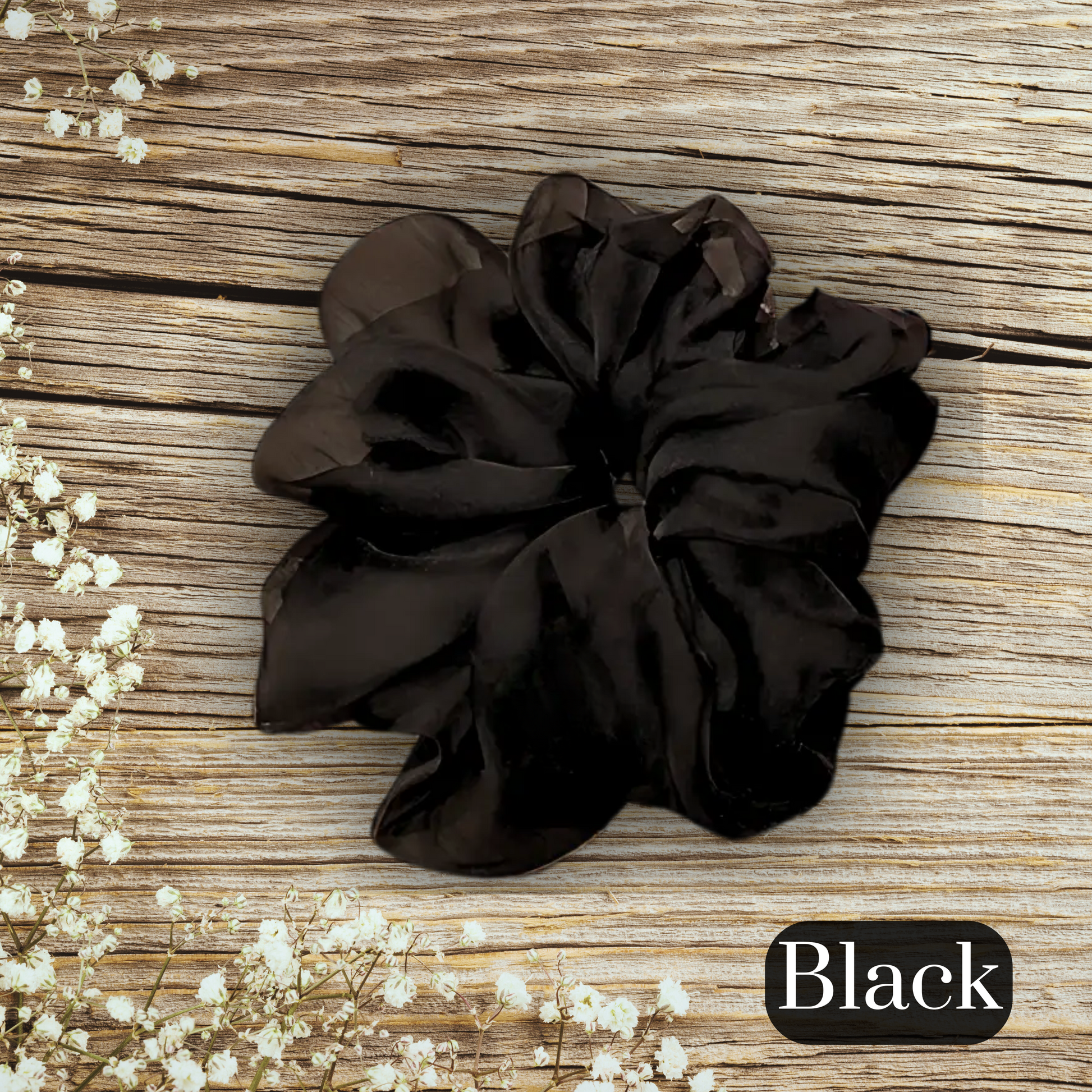 chiffon scrunchie in black on a large wood table measuring 16 cm in diameter