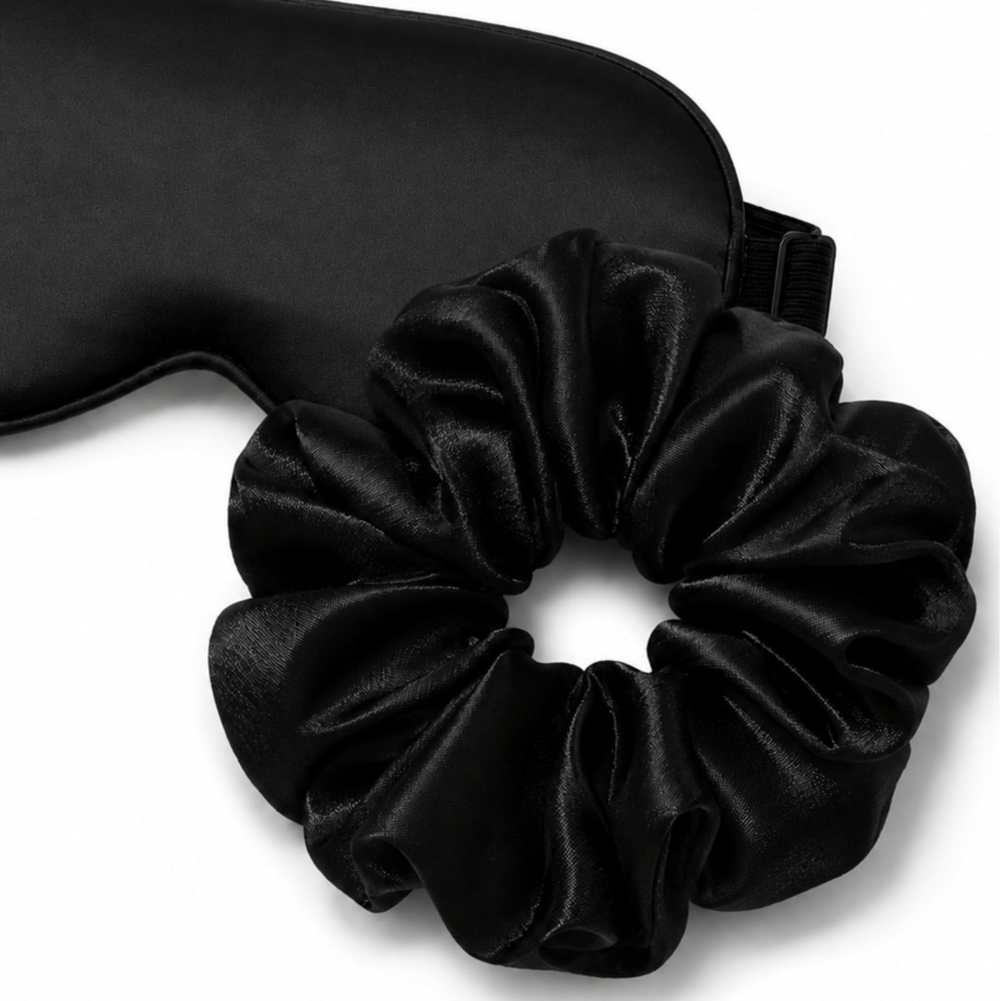 Close-up of satin eye mask and oversized scrunchie sleep set