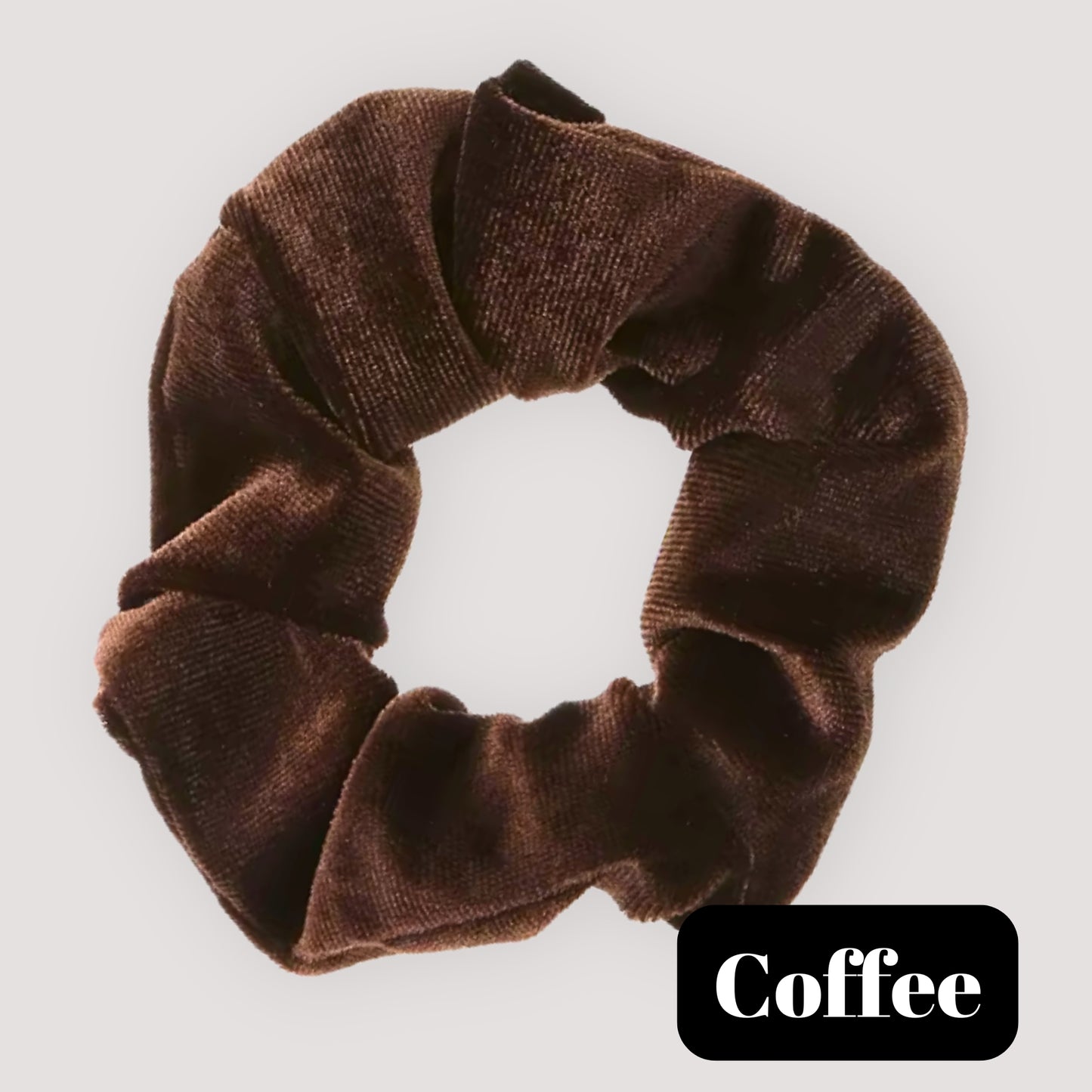 A single Coffee brown handmade velvet scrunchie for damage-free hair styling on a light background, featuring a black label reading 'Coffee'.