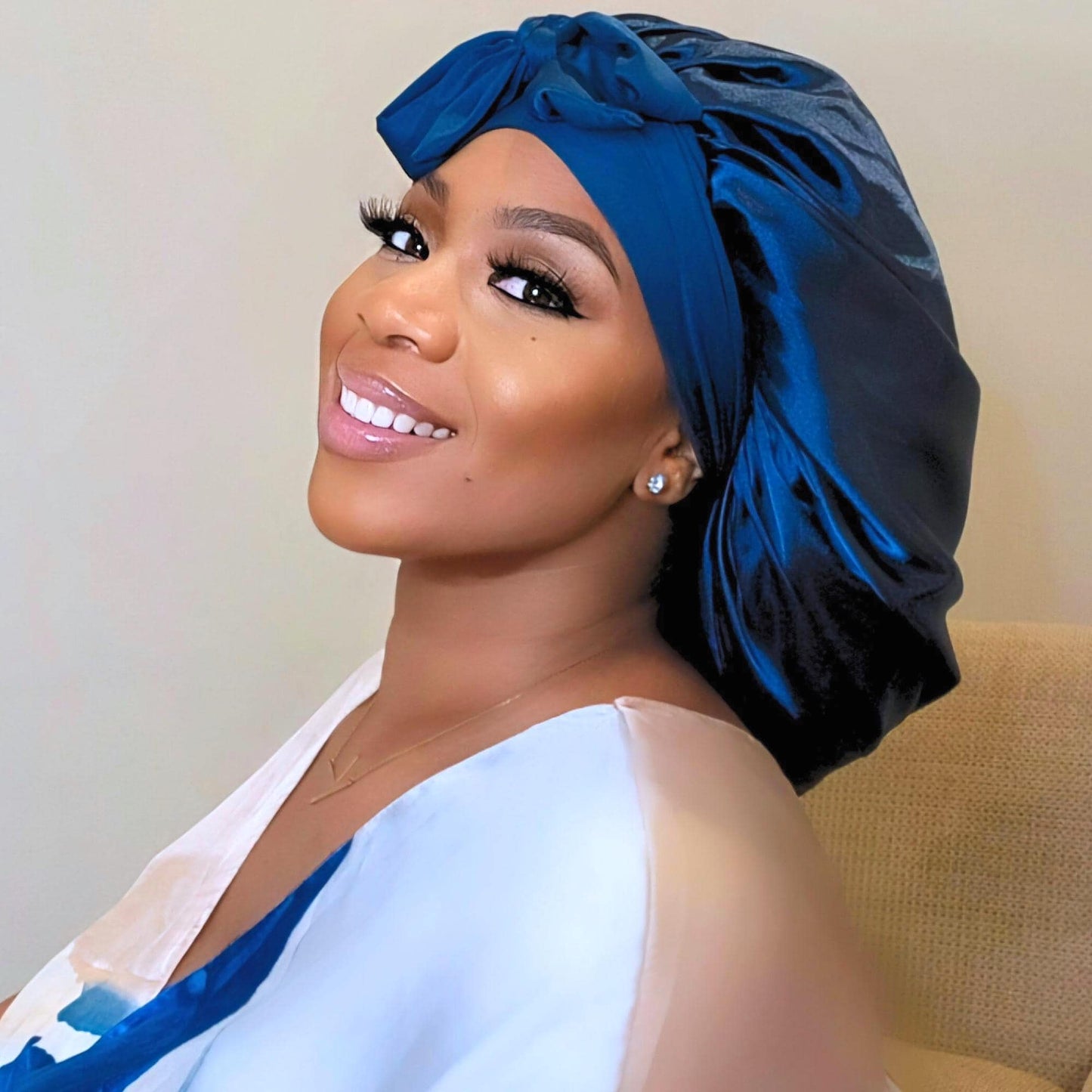 Double layer satin stretch tie hair bonnet in reversible colors, designed for women and children with natural, curly, or textured hair; adjustable fit with silky finish for sleep or daily wear