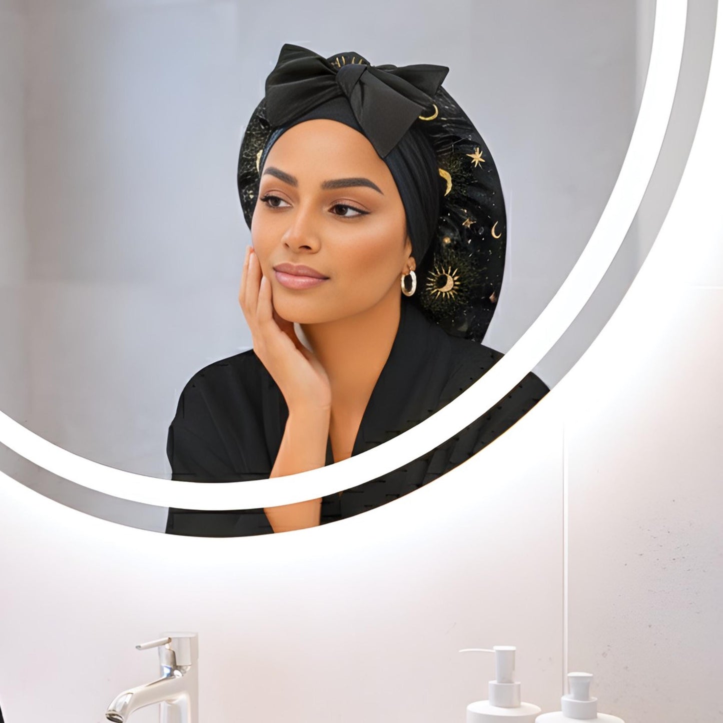 Biracial woman wearing a large Handmade Charmeuse Silk Satin Sleep Bonnet in a Celestial Starry Night Cosmic Print with adjustable stretch ties. Features a double-layer satin design that protects hair from frizz and breakage while locking in moisture. Unisex silk bonnet made in the USA by Prince Hair Company.