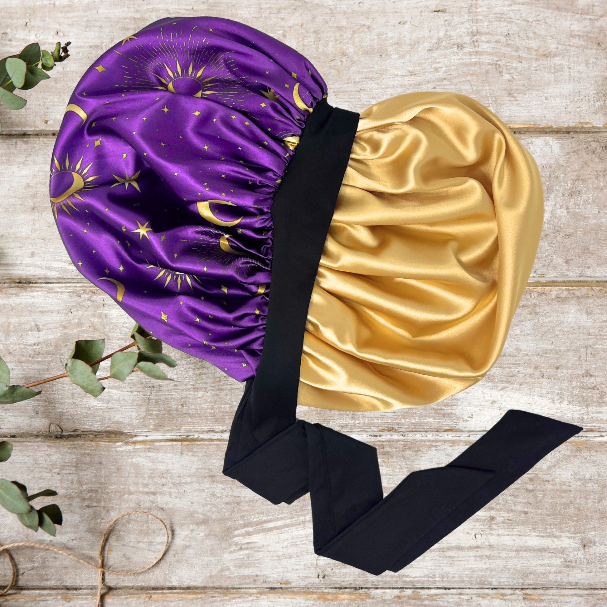 Interior view of the Celestial Plum bonnet highlighting the high-quality gold satin lining and black stretch tie.