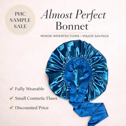 Peacock blue satin stretch-tie bonnet displayed in a Prince Hair Company Almost Perfect sample sale graphic showing that the bonnet is wearable with minor imperfections.