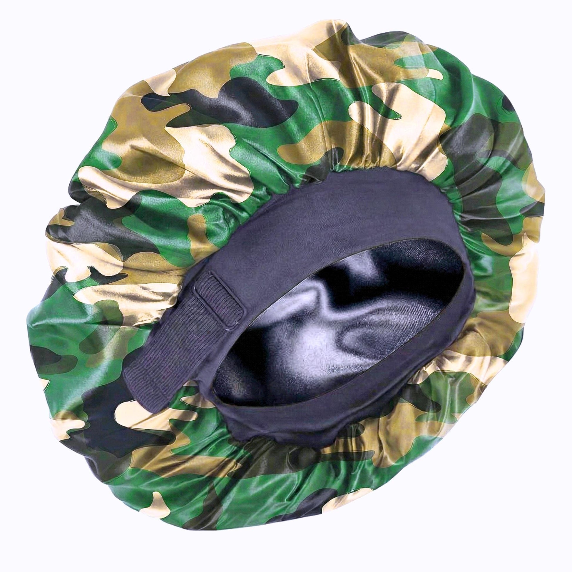 Close-up product photo of a camo satin bonnet on a white background, showing the wide black band, adjustable strap, and shiny black lining inside.