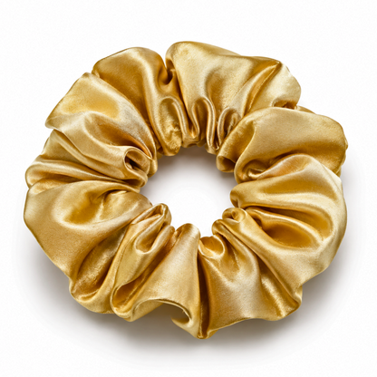 Oversized gold satin scrunchie on a clean white background