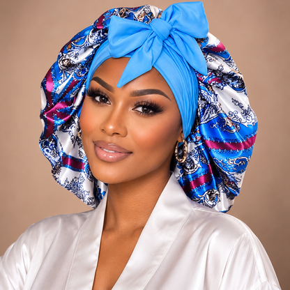 Blue Damask satin bonnet with blue, pink and white print and a bright blue bow