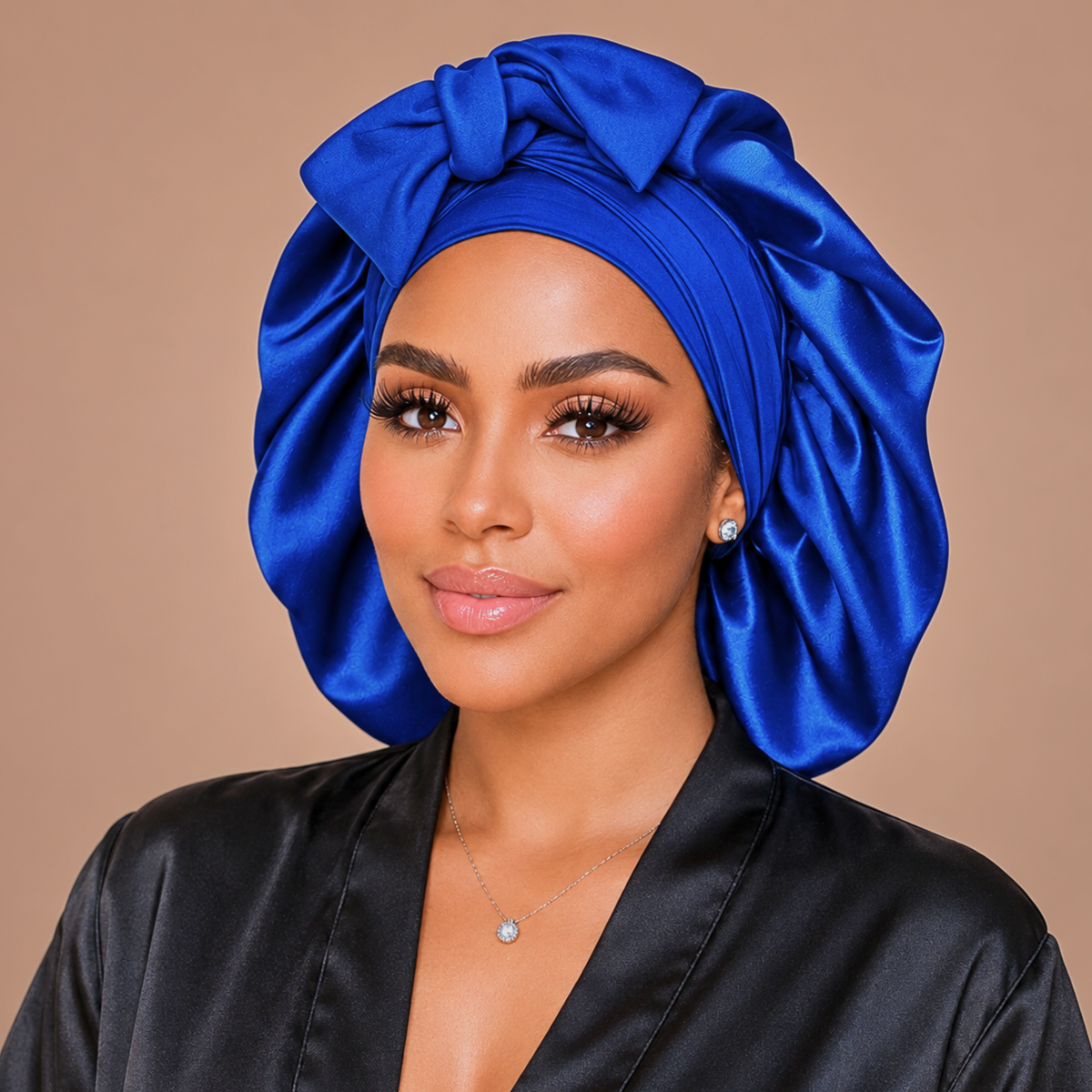 Royal Blue silk-blend satin bonnet with stretch ties, large size – front view of the gathered crown and bow, worn with a black satin robe