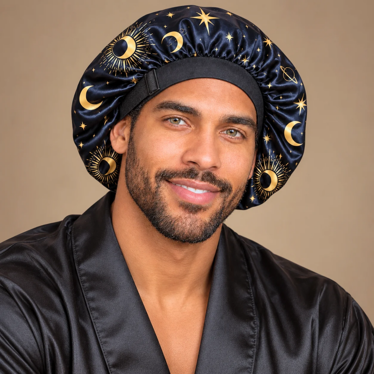 Man wearing the Starry Night no-tie satin bonnet with gold celestial print and an adjustable black band.