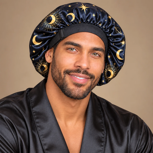 Man wearing the Starry Night no-tie satin bonnet with gold celestial print and an adjustable black band.