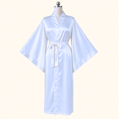 A white satin kimono robe displayed on a mannequin torso against a plain light beige background.