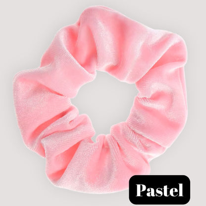 A single Pastel light pink handmade velvet scrunchie for damage-free hair styling on a light background, featuring a black label reading 'Pastel'.