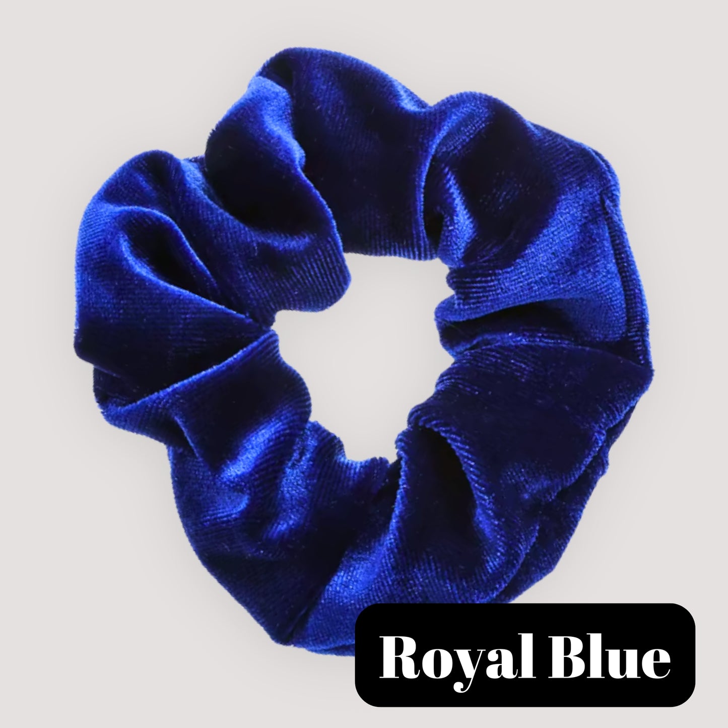 A single Royal Blue handmade velvet scrunchie for damage-free hair styling on a light background, featuring a black label reading 'Royal Blue'.