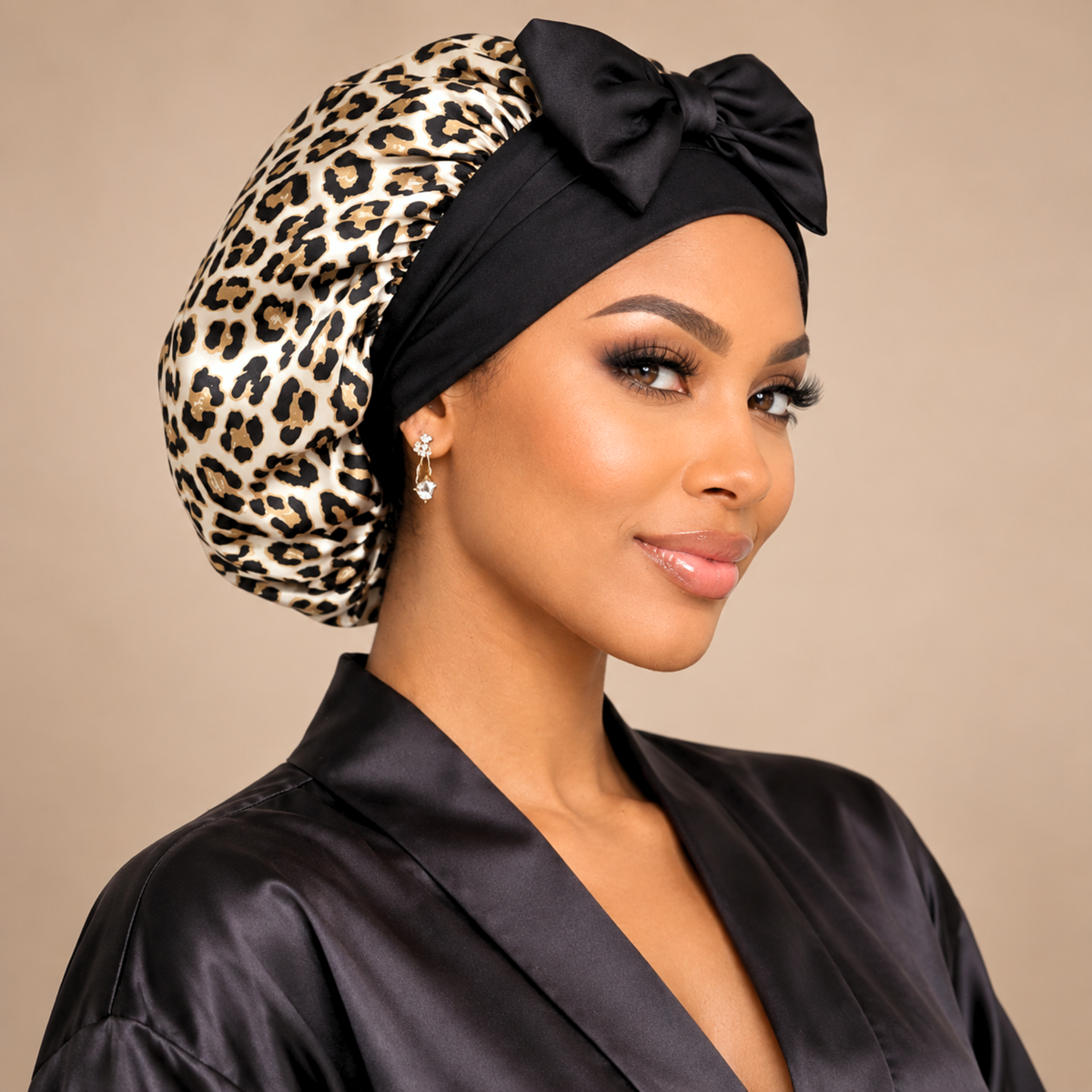 Leopard Print silk-blend satin bonnet with stretch ties, small size – front view with black bow, worn with a black satin robe