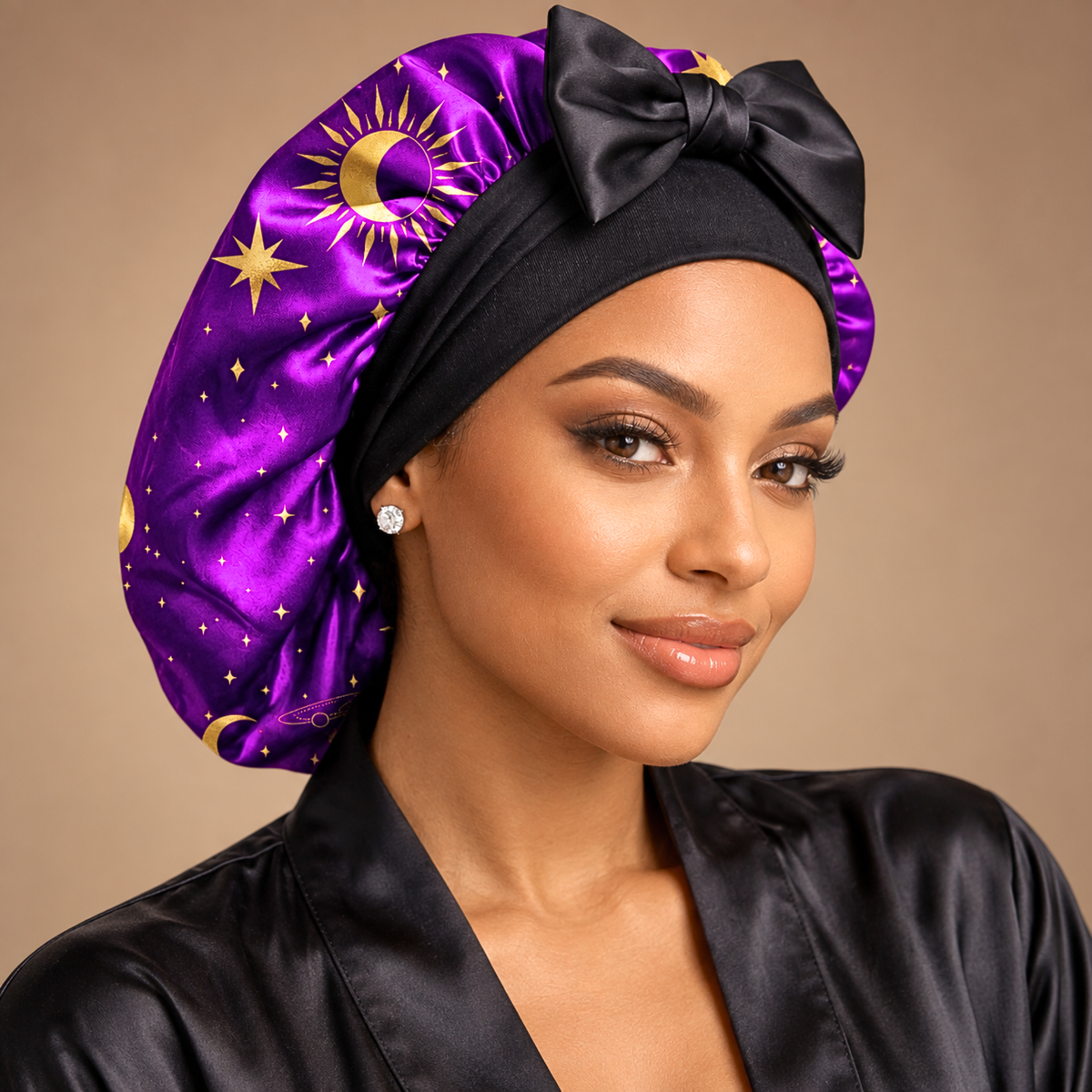 Celestial Dream silk-blend satin bonnet with stretch ties, small size – front view of the purple and gold celestial print, worn with a black satin robe